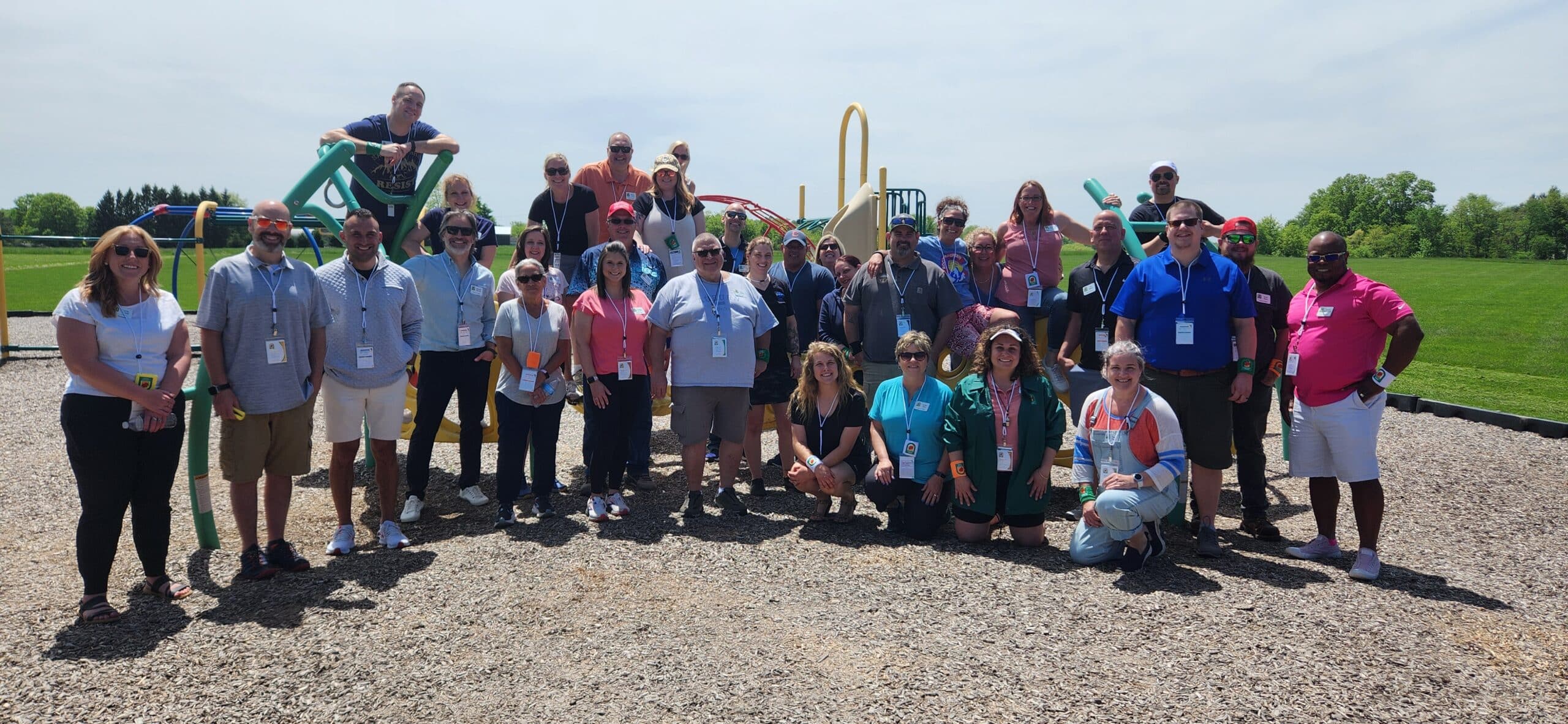Adults posing for a picture on a playground